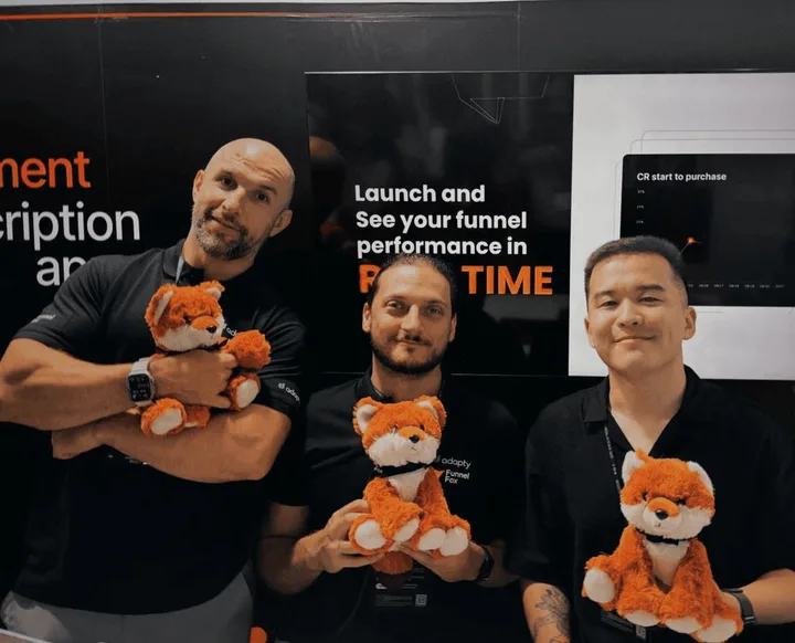 Colleagues at the FunnelFox conference booth